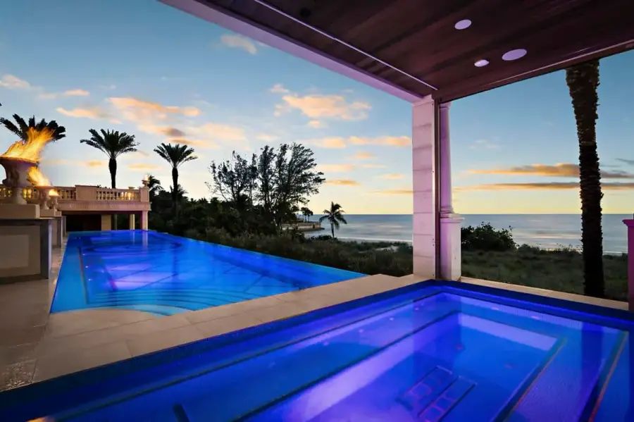 Contemporary Tampa pool with blue LED lighting and a seamless edge, perfect for evening relaxation and gatherings.