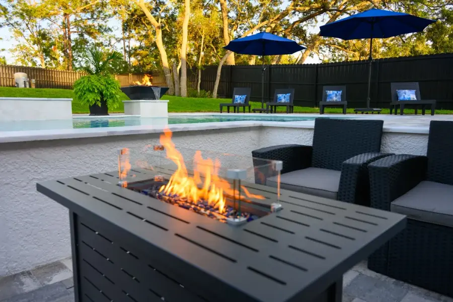 Poolside seating area with a fire pit