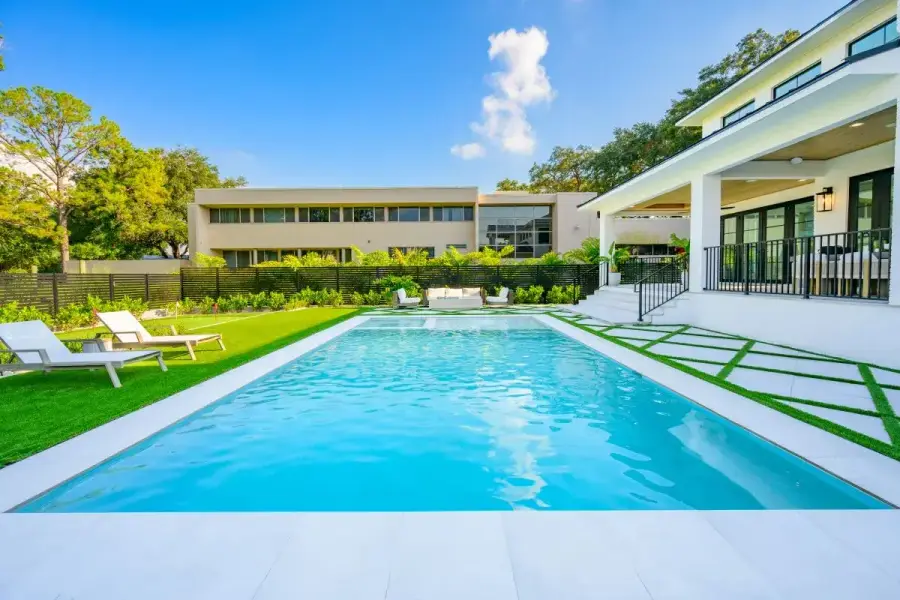 Elegant backyard pool with clean lines and light stone pavers
