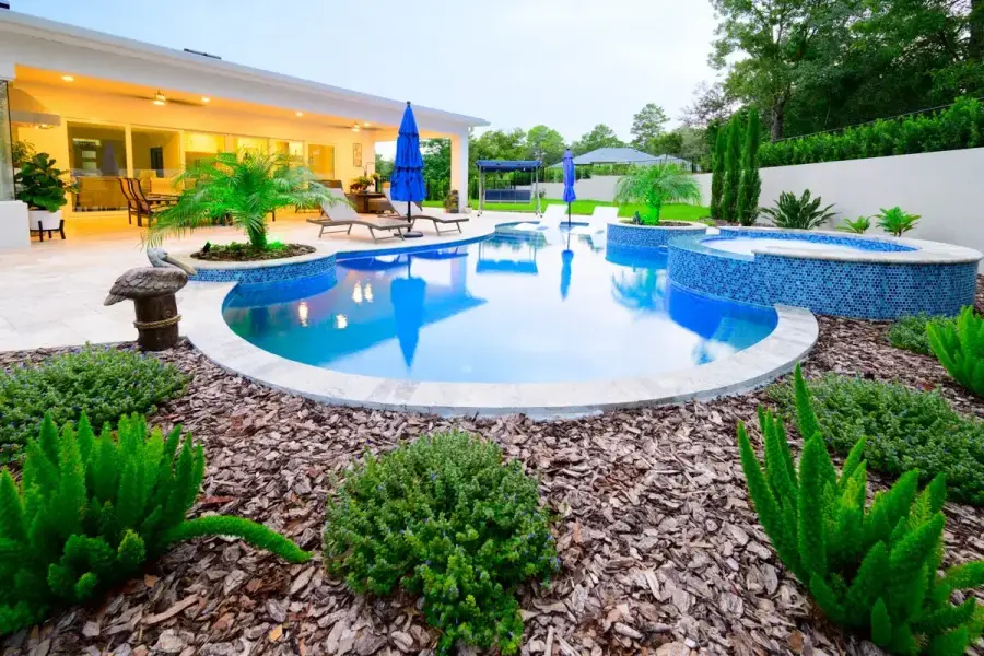 Spacious Weeki Wachee backyard featuring a pool with a curved design