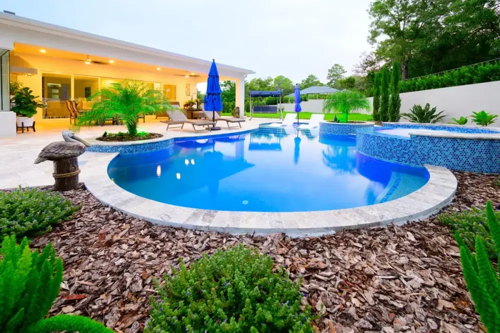 Beautiful Weeki Wachee backyard pool with a curved design, vibrant landscaping