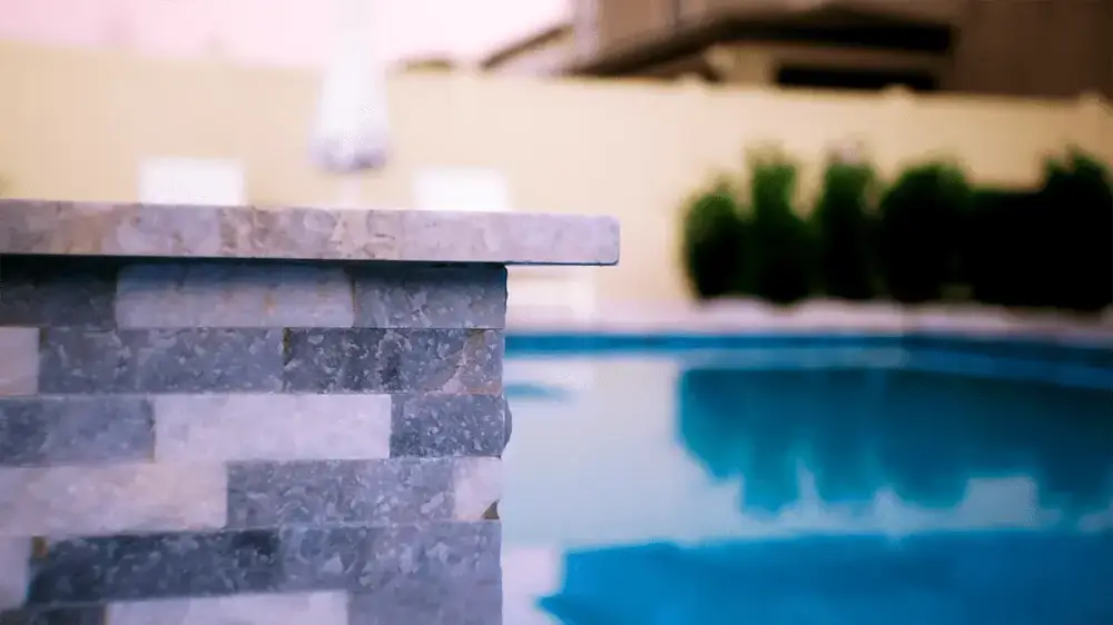 detail view of stonework on the side of a custom pool near tampa florida