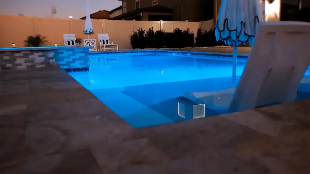 night view of sunshelf and led lighting on gorgeous pool near tampa