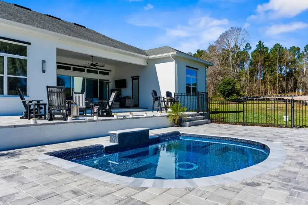Stylish Pool and Spa with Elegant Surrounding Hardscape