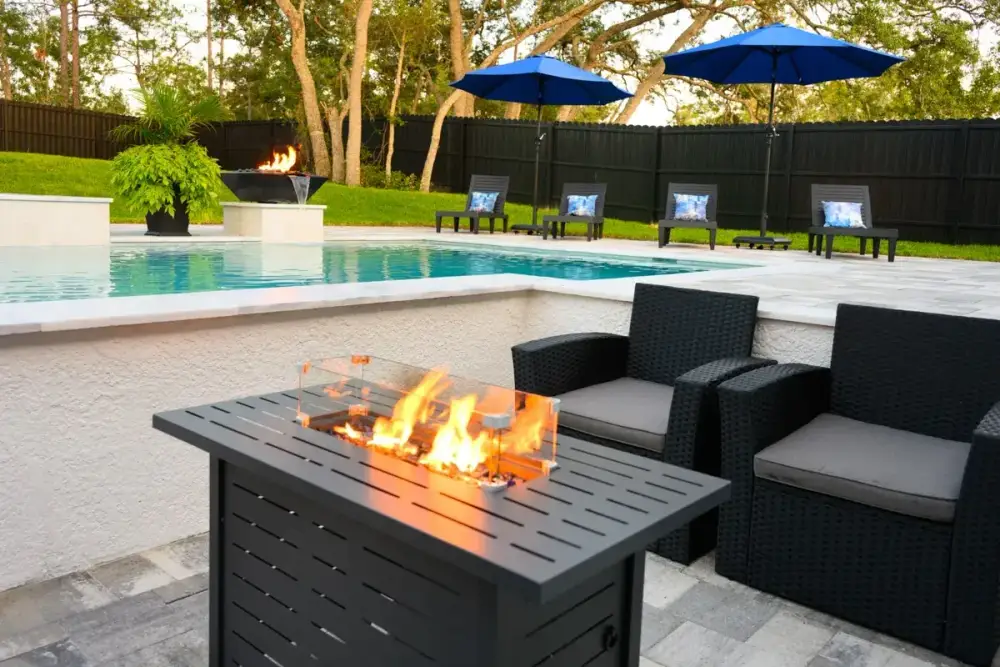 Vibrant pool with clear blue water, surrounded by a manicured lawn and comfortable seating